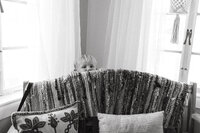 A boy peeks over a couch during an at home family session in Houston Texas