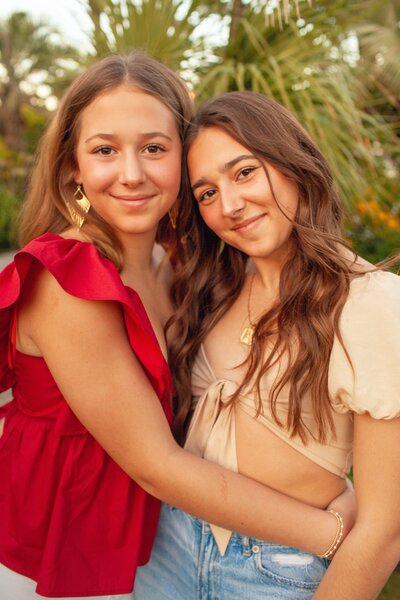 Sisters taking photos at Wrightsville beach, NC Wrightsville beach high school senior photos at Trailborn Surf and Sound formerly Blockade Runner Beach Resort.