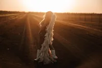 Woman wearing angel wings during an editorial boudoir session near Wichita, Kansas.