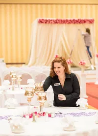 Wedding planner sets up wedding decor