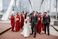 Bride and groom portrait with bridal party walking down the bridge at Nashville Tennessee wedding — Weddings & Events by Raina