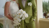 Wedding florals and green grooms suit