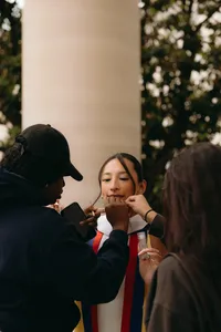 Makeup team working with human before graduation