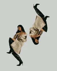 Human wearing tan trench dress and knee-high black boots, one looking to the left and the other upside down