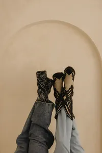 Two sets of feet up in the air in front of an archway