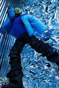 Blue image with textured elements in the background with dark color pants