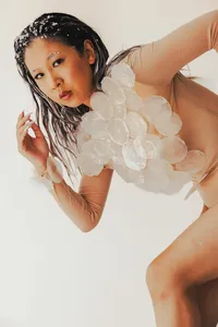 Human looking at the camera with white texture pattern covering their upper body