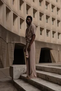 Human looking at camera with beautiful sculptured building around them