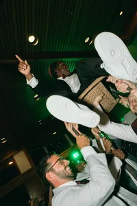 Person being held up in a chair on their celebration of love