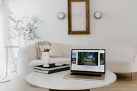 Tami Luger Real Estate website displayed on a laptop in a bright neutral interior.