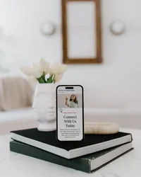 Mobile Dower & Associates Showit website displayed on a phone in a neutral interior.