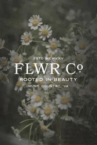 FLWR Co logo set over a dark still life of white flowers