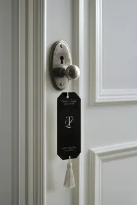 Tami Luger Real Estate branded door hanger featuring the TL monogram displayed on an interior door.