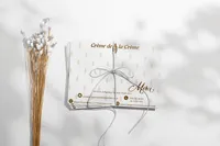 Crème de la Crème printed card featuring gold typography and branded details.