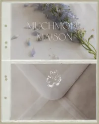 Muchmore Maison invitation and envelope suite featuring the brand's soft neutral palette and floral details.