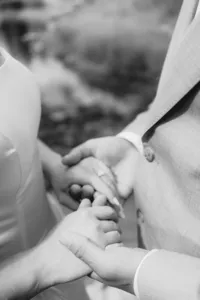 A close up of a couple holding hands.