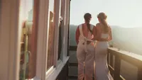 A couple looking out in the distant sunset.