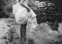An insert of a bride walking into a lake.