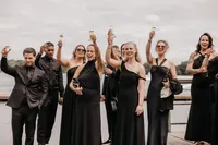 proostende gasten op bruiloft aan het water met black tie dresscode