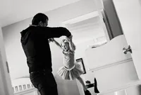 Minneapolis family photographer capturing a joyful father spinning his daughter during a playful in-home family session in Minnesota.