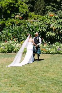Bride and groom standing together on the lawn at Hatley Castle