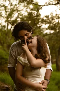 Engaged couple laughing together during an outdoor session