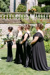 Bridesmaids standing together in the garden at Hatley Castle