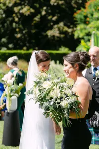 Bride carrying her bouquet during an outdoor ceremony at Hatley Castle