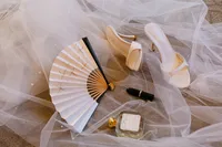 Wedding rings and personal details arranged on a white veil