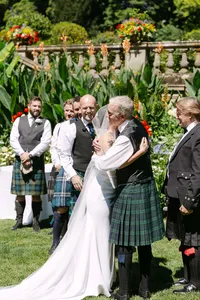 Bride and groom sharing a moment with family during their outdoor wedding