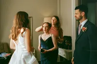 Bride with bridesmaids and groom getting ready at an Oxford wedding, 35mm film