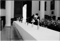 Long dinner table set with flowers at Worcester College Oxford, black and white 35mm film