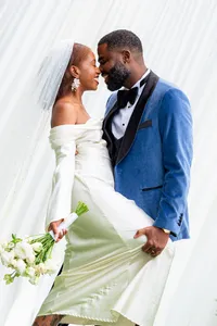 Bride and groom smiling nose to nose in wedding attire