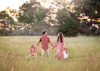 family-walking-through-meadow-bespoke-family-photography