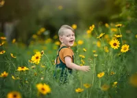boy-child-smiling-in-yellow-flower-field-box-hill