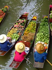 Colorful fresh produce and local foods displayed at a vibrant outdoor market on the water