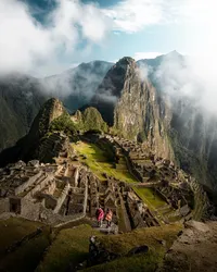 Machu Picchu ruins surrounded by dramatic green mountains in Peru