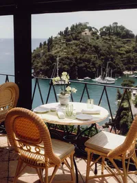 Elegant outdoor dining table overlooking a scenic Mediterranean landscape
