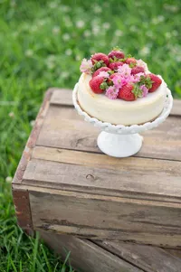 Wedding cake with fresh strawberries and pink flowers at a Lowcountry wedding near Johns Island and Wadmalaw Island SC photographed by Amberlee Christey.