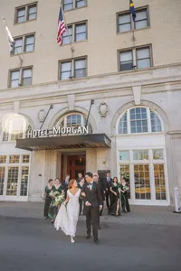 Bride, groom, and wedding party outside Hotel Morgan in Morgantown, West Virginia, photographed by Amberlee Christey.