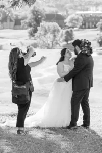 Behind-the-scenes wedding photography at The Links at Woodridge with Amberlee Christey photographing a bride and groom outdoors.