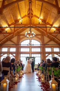 Bride and groom during their indoor wedding ceremony at Stonewall Resort in Roanoke, West Virginia, photographed by Amberlee Christey.