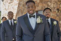 Groom and groomsmen in navy tuxedos photographed at a wedding in Greenville, South Carolina by Amberlee Christey.