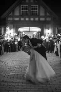 Bride and groom kissing during a sparkler exit at Highgate Carriage House in Fairmont, West Virginia, photographed by Amberlee Christey.