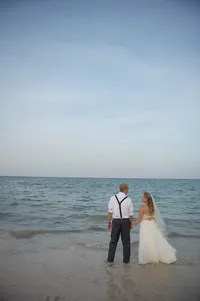 Bride and groom standing at the oceanfront at The Breakers in Palm Beach, Florida, photographed by Amberlee Christey Photography.