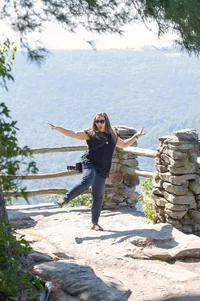 Amberlee Christey with her camera at Coopers Rock State Forest near Morgantown, West Virginia, surrounded by mountain views.