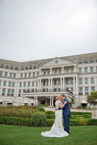 Bride and groom embracing in the gardens at Nemacolin Resort in Farmington, Pennsylvania, photographed by Amberlee Christey.