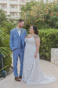 Bride and groom sharing a joyful moment surrounded by tropical greenery during their Palm Beach, Florida wedding.