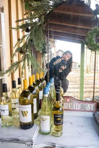 Behind-the-scenes portrait of wedding photographer Amberlee Christey with her camera at a festive holiday setting in Myrtle Beach, South Carolina.