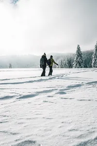two-people-walking-on-snow-6753522